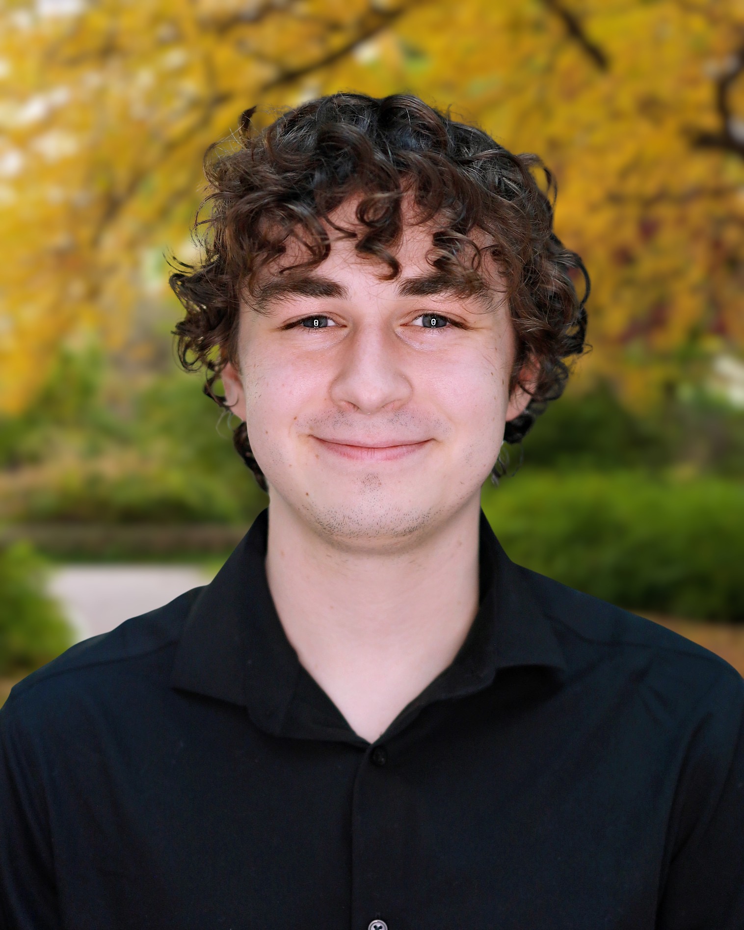 Headshot of Ian Forehand, smiling, wearing a black shirt.